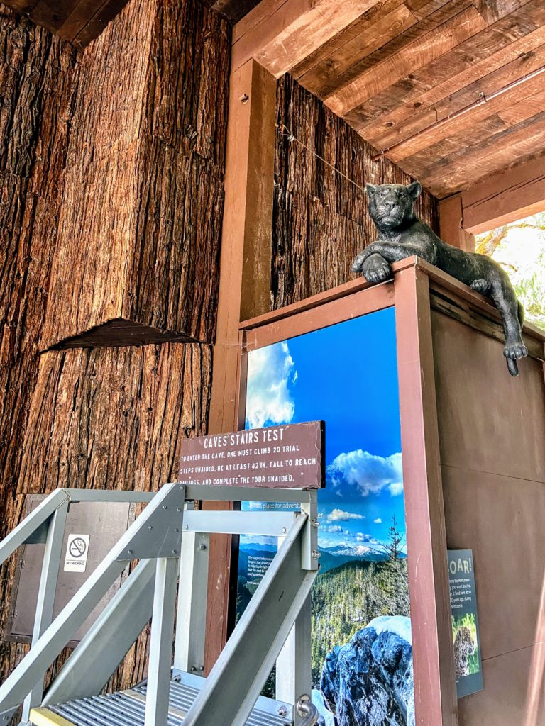 a statue looks over the Oregon Caves Visitor Center