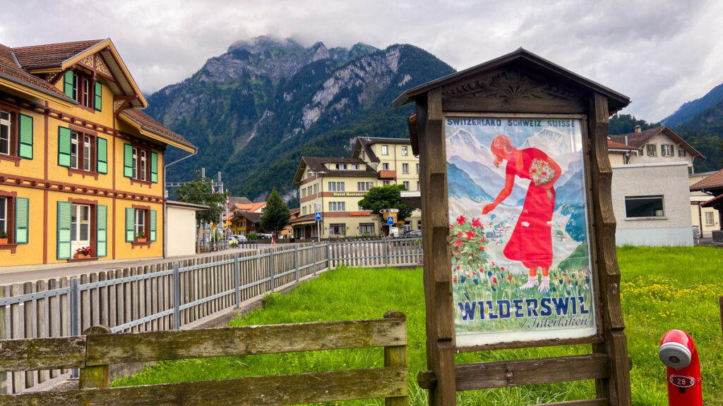 image shows a vintage sign for Wilderswil with a backdrop of mountains