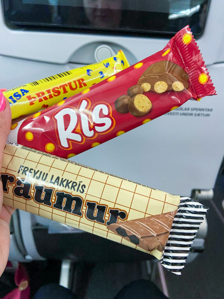 image shows three candy bars in front of a airplane tray table